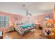 Bright and airy bedroom with a queen size bed, a ceiling fan, and two bedside tables at 742 Portwine Ct # 17, Englewood, FL 34223