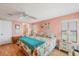 Bedroom featuring a queen bed with bedside tables and a Primary bath through the door at 742 Portwine Ct # 17, Englewood, FL 34223