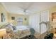 Comfortable bedroom featuring a bed, white ceiling fan, a double closet, and natural light from the window at 742 Portwine Ct # 17, Englewood, FL 34223