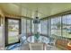 Charming dining area featuring a glass table, chairs, blinds and plenty of natural light at 742 Portwine Ct # 17, Englewood, FL 34223