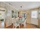 Cozy dining room features a glass table with wicker chairs and built-in display cabinets at 742 Portwine Ct # 17, Englewood, FL 34223