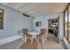 Enclosed porch with a table and chairs, providing a cozy space for outdoor relaxation at 742 Portwine Ct # 17, Englewood, FL 34223