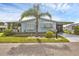 Inviting single-story home with shutters, lush landscaping, and a convenient carport at 742 Portwine Ct # 17, Englewood, FL 34223