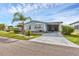 Charming single-story home featuring a well-maintained lawn, palm tree, and covered carport at 742 Portwine Ct # 17, Englewood, FL 34223
