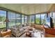 Inviting sunroom featuring a comfortable sofa, large windows, and plenty of natural light and serene views at 742 Portwine Ct # 17, Englewood, FL 34223