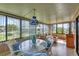 Sunroom showcasing both the dining and living spaces with lots of natural light at 742 Portwine Ct # 17, Englewood, FL 34223