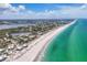 Scenic aerial view of beachfront homes along stunning turquoise ocean and serene waterways at 7554 Palm Island S Dr # 1813, Placida, FL 33946