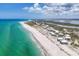Breathtaking aerial view of homes nestled along the coastline with turquoise waters at 7554 Palm Island S Dr # 1813, Placida, FL 33946