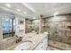 Bright bathroom with double sinks, granite counters, and a modern, tiled shower at 7554 Palm Island S Dr # 1813, Placida, FL 33946
