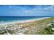 Expansive beach with pristine sand and clear blue water, bordered by lush vegetation at 7554 Palm Island S Dr # 1813, Placida, FL 33946