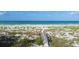 Picturesque view of a boardwalk leading to a sandy beach and calm, inviting waters at 7554 Palm Island S Dr # 1813, Placida, FL 33946