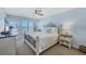 Inviting bedroom with ocean view, white bedding, and decorative wrought iron bed frame at 7554 Palm Island S Dr # 1813, Placida, FL 33946