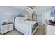 Comfortable bedroom with light blue walls, white bedding, and en suite bathroom access at 7554 Palm Island S Dr # 1813, Placida, FL 33946
