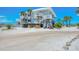 Light blue exterior with stairs leading to balconies, set against a backdrop of clear blue skies at 7554 Palm Island S Dr # 1813, Placida, FL 33946