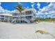 Stunning two-story beachfront home with screened in decks and a beautiful palm tree at 7554 Palm Island S Dr # 1813, Placida, FL 33946