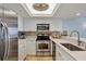Well-equipped kitchen with stainless steel appliances, white cabinetry, and a stylish backsplash at 7554 Palm Island S Dr # 1813, Placida, FL 33946