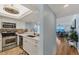 Modern kitchen with stainless steel appliances and open floor plan flows into a cozy living room with ocean views at 7554 Palm Island S Dr # 1813, Placida, FL 33946