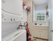 The laundry area features a stackable washer/dryer and storage in this charming beach home at 7554 Palm Island S Dr # 1813, Placida, FL 33946