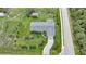 Aerial view of the house showcasing the roof, driveway, and mature landscaping at 7690 Castleberry Ter, Englewood, FL 34224
