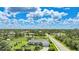 Aerial view of a charming home, landscaped yard and surrounding residential area at 7690 Castleberry Ter, Englewood, FL 34224