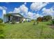 Backyard with a shed, patio, and lush lawn at 7690 Castleberry Ter, Englewood, FL 34224