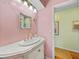 Updated bathroom features a decorative vanity and seashell mirror at 7690 Castleberry Ter, Englewood, FL 34224
