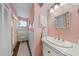 Pink bathroom featuring decorative vanity and seashell mirror at 7690 Castleberry Ter, Englewood, FL 34224
