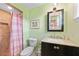 Updated bathroom with tile shower, vanity with decorative mirror, and modern fixtures at 7690 Castleberry Ter, Englewood, FL 34224