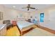 Comfortable bedroom featuring a ceiling fan, hardwood floors, and colorful decor at 7690 Castleberry Ter, Englewood, FL 34224