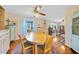 Inviting dining room features a round table with windows offering natural light at 7690 Castleberry Ter, Englewood, FL 34224