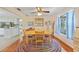 Cozy dining room with a round table, colorful rug, and built-in display cabinet at 7690 Castleberry Ter, Englewood, FL 34224