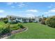 Charming single-story home with a well-manicured lawn and colorful landscaping at 7690 Castleberry Ter, Englewood, FL 34224