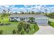 Charming single-story home featuring a manicured lawn and an inviting pink front door at 7690 Castleberry Ter, Englewood, FL 34224