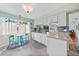 Well-lit kitchen with white cabinetry, granite counters, and charming decor details at 7690 Castleberry Ter, Englewood, FL 34224