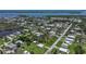 Wide aerial view of the neighborhood and surrounding waterways, dotted with lush trees at 8224 Pinetree Ln, Englewood, FL 34224