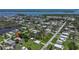 High aerial view of the neighborhood and surrounding waterways, dotted with lush trees at 8224 Pinetree Ln, Englewood, FL 34224