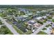 Captivating aerial view of waterfront properties and construction on the canal, surrounded by lush trees at 8224 Pinetree Ln, Englewood, FL 34224