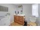 Well-lit bathroom features a wood vanity, white countertop, and decorative accents at 8224 Pinetree Ln, Englewood, FL 34224