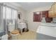 Functional bathroom with a toilet, utility sink, and washer/dryer hookups at 8224 Pinetree Ln, Englewood, FL 34224