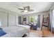 Bedroom with a ceiling fan, natural light, and stylish decor at 8224 Pinetree Ln, Englewood, FL 34224