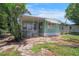 Exterior of the home with well-kept landscaping and a small front porch at 8224 Pinetree Ln, Englewood, FL 34224
