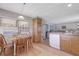 Bright kitchen and dining area with wood cabinets, appliances, and connection to the living room at 8224 Pinetree Ln, Englewood, FL 34224