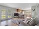 Cozy living room featuring comfortable seating, natural light, and an open layout to the kitchen at 8224 Pinetree Ln, Englewood, FL 34224