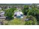 Overhead view of a cozy single-story home with shade trees and carport at 8224 Pinetree Ln, Englewood, FL 34224