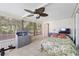 Relaxing sunroom featuring tile floors, tropical ceiling fan, and view of the outdoors at 8224 Pinetree Ln, Englewood, FL 34224