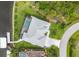 Bird's-eye view of the house featuring a pool, boat dock, lush lawn, and circular driveway at 10079 Lebanon Dr, Port Charlotte, FL 33981