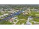 A high aerial view shows the property nestled on the water with neighboring homes and stunning canal views at 10079 Lebanon Dr, Port Charlotte, FL 33981