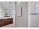 Stylish primary bathroom featuring modern fixtures, a large mirror, and tiled walk-in shower at 10079 Lebanon Dr, Port Charlotte, FL 33981