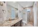 Bathroom features a modern vanity with stone countertop and walk-in shower at 10079 Lebanon Dr, Port Charlotte, FL 33981