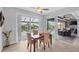 Dining area with views of the screened-in lanai and pool area, creating a serene atmosphere at 10079 Lebanon Dr, Port Charlotte, FL 33981